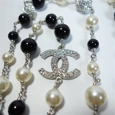 chanel black and white pearl necklace|Chanel long necklace with logo.